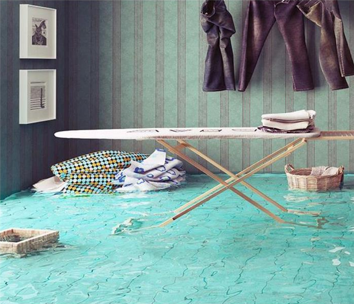 a flooded bedroom with furniture floating in the water