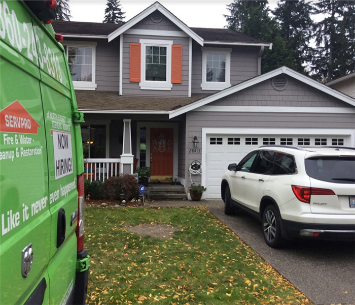 a SERVPRO truck parked in front of a home