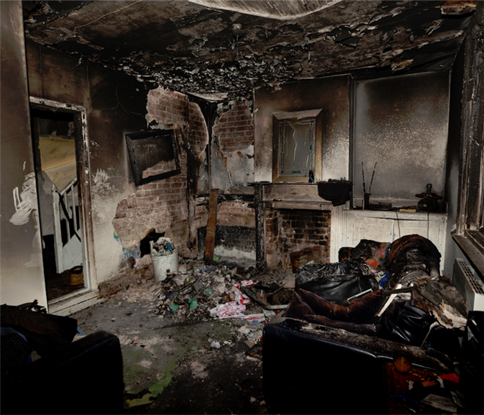 a fire damaged room with debris everywhere