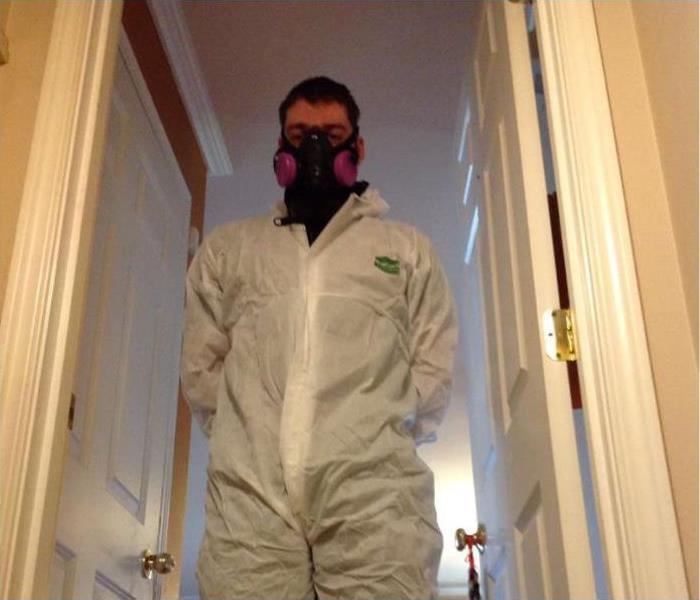 employee in PPE wearing a mask